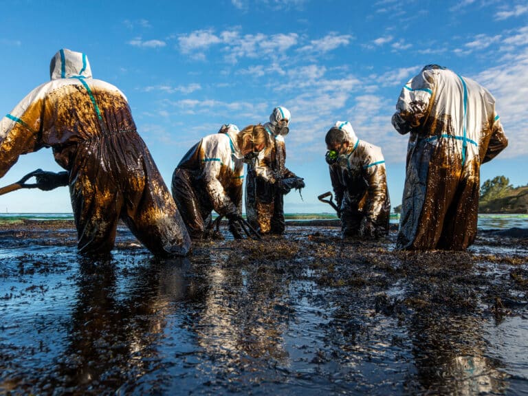 Workers remove crude oil